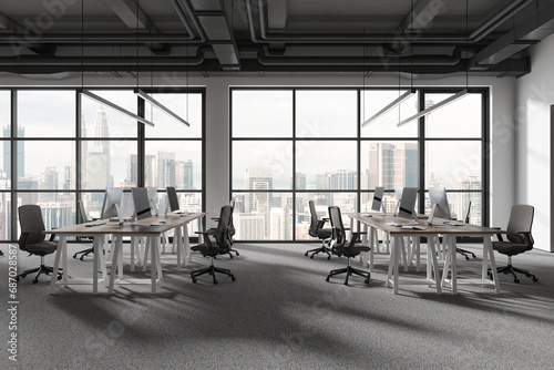 Grey office workspace interior with pc desktop and panoramic window