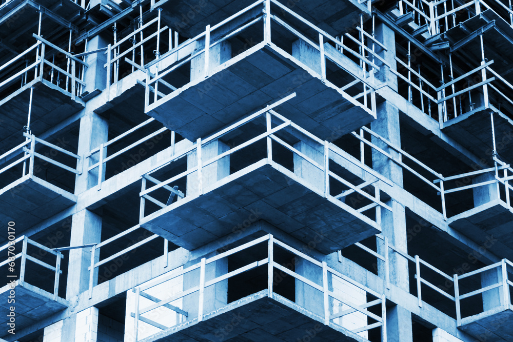 Luxurious apartments for sale. Bricks and concrete. Construction site background. High block of flats living area. New building neighborhood in progress. Real estate market in Europe. Blue background. Luxurious apartments for sale. Bricks and concrete. Construction site background. High block of flats living area. New building neighborhood in progress. Real estate market in Europe. Blue background.