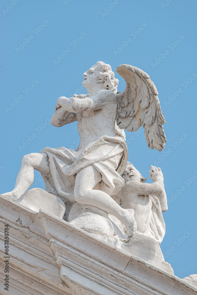 Venice, Italy. Beautiful angel with wings and light. Church Chiesa di Santa Maria Assunta, Baroque catholic church with sacred medieval art Venice, Italy. Beautiful angel with wings and light. Church Chiesa di Santa Maria Assunta, Baroque catholic church with sacred medieval art