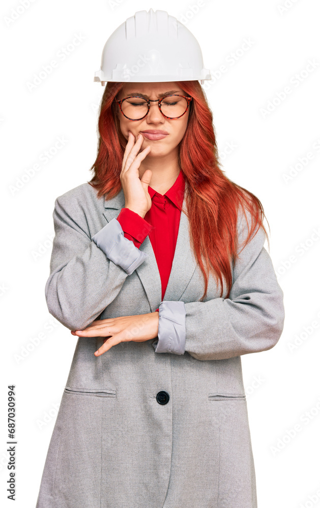 Young redhead woman wearing architect hardhat touching mouth with hand with painful expression because of toothache or dental illness on teeth. dentist Young redhead woman wearing architect hardhat touching mouth with hand with painful expression because of toothache or dental illness on teeth. dentist