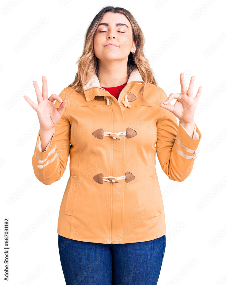 Young caucasian woman wearing casual clothes relax and smiling with eyes closed doing meditation gesture with fingers. yoga concept. Young caucasian woman wearing casual clothes relax and smiling with eyes closed doing meditation gesture with fingers. yoga concept.