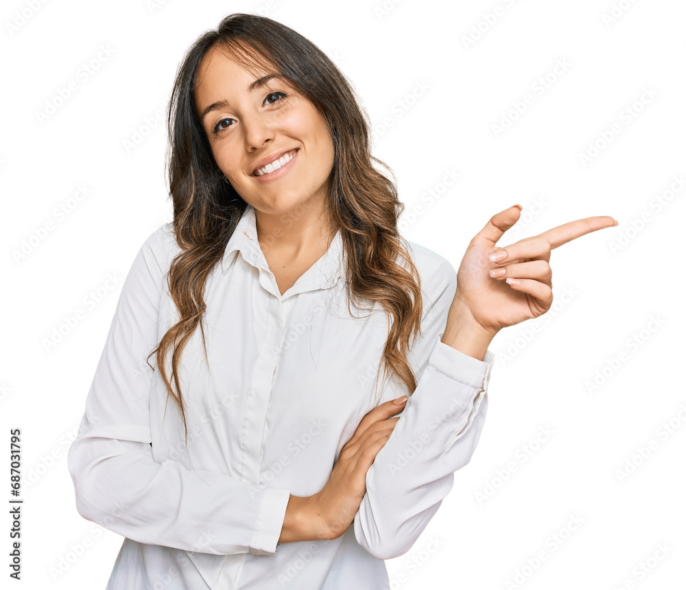 Young brunette woman wearing casual clothes with a big smile on face, pointing with hand and finger to the side looking at the camera. Young brunette woman wearing casual clothes with a big smile on face, pointing with hand and finger to the side looking at the camera.