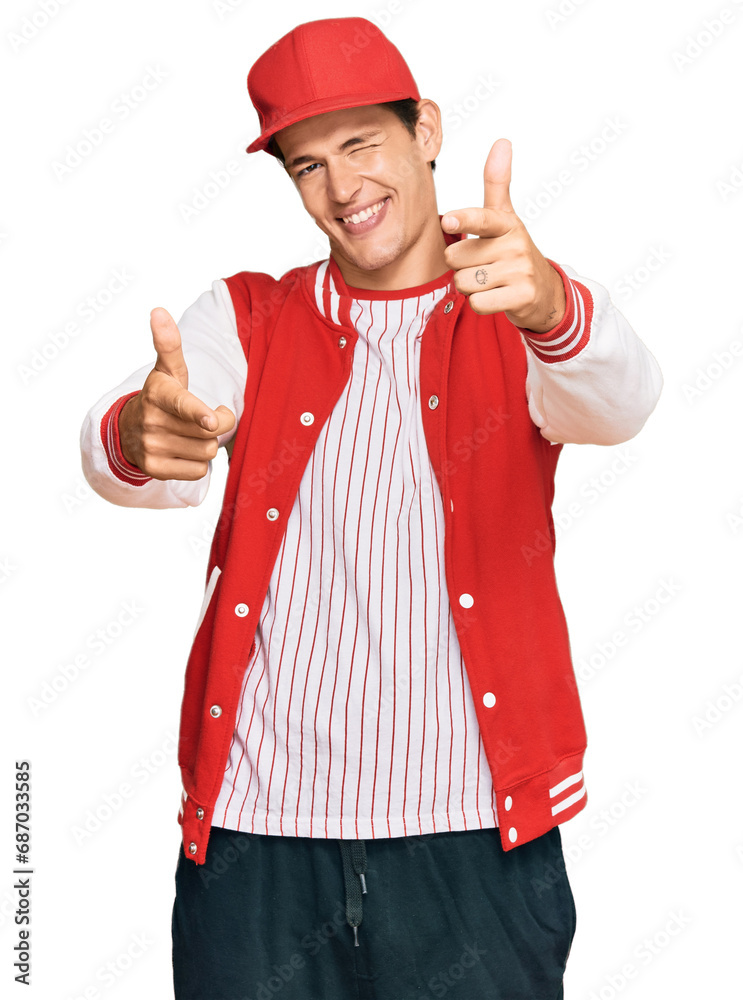 Handsome caucasian man wearing baseball uniform pointing fingers to camera with happy and funny face. good energy and vibes. Handsome caucasian man wearing baseball uniform pointing fingers to camera with happy and funny face. good energy and vibes.