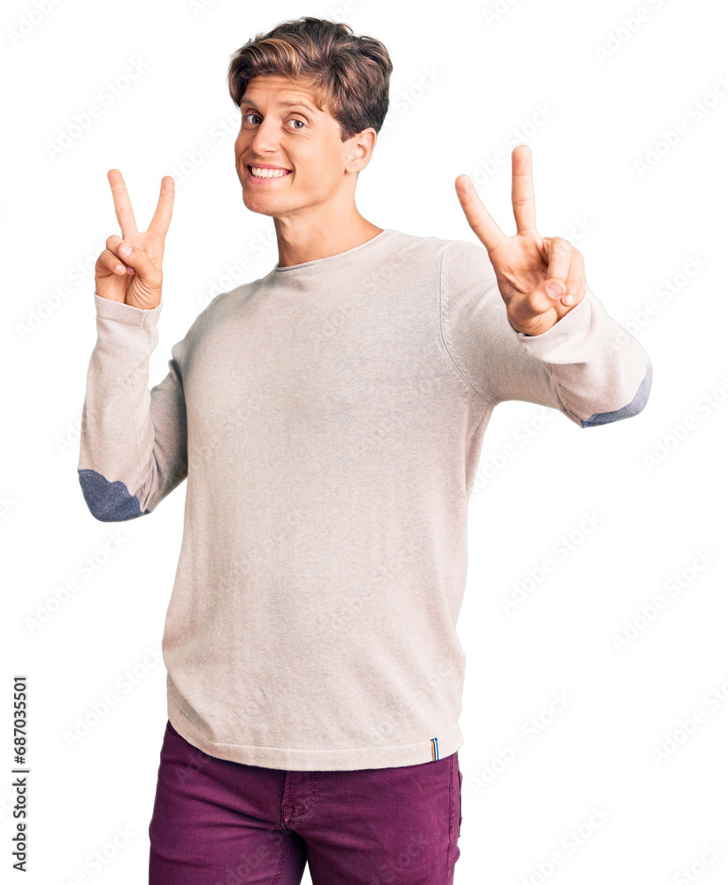 Young handsome man wearing casual clothes smiling looking to the camera showing fingers doing victory sign. number two. Young handsome man wearing casual clothes smiling looking to the camera showing fingers doing victory sign. number two.