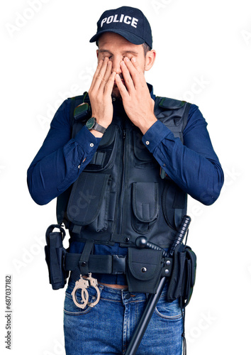 Young handsome man wearing police uniform rubbing eyes for fatigue and headache, sleepy and tired expression. vision problem