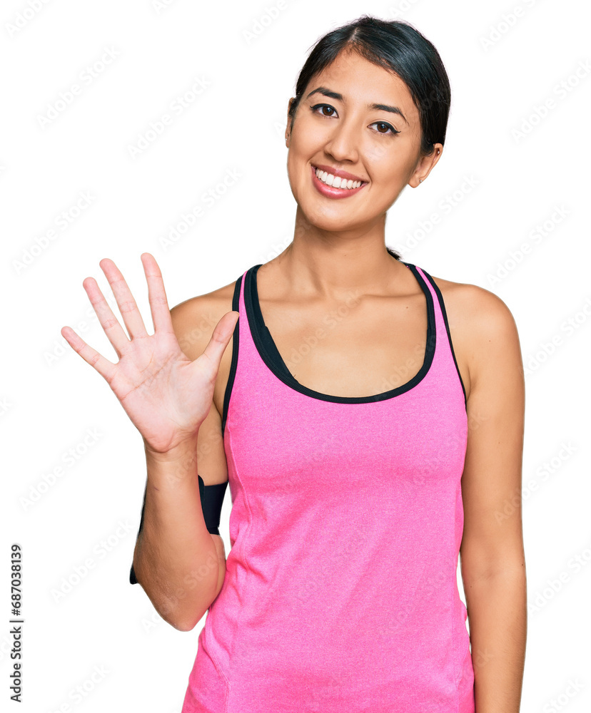 Beautiful asian young sport woman wearing sportswear and arm band showing and pointing up with fingers number five while smiling confident and happy. Beautiful asian young sport woman wearing sportswear and arm band showing and pointing up with fingers number five while smiling confident and happy.