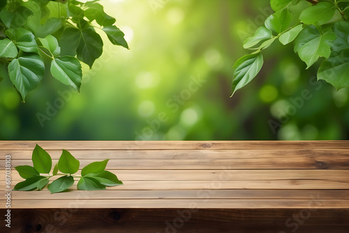 Empty wooden table with green leaf background 