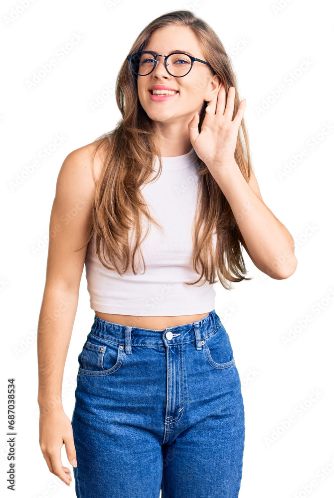 Beautiful caucasian young woman wearing casual clothes and glasses smiling with hand over ear listening an hearing to rumor or gossip. deafness concept. Beautiful caucasian young woman wearing casual clothes and glasses smiling with hand over ear listening an hearing to rumor or gossip. deafness concept.
