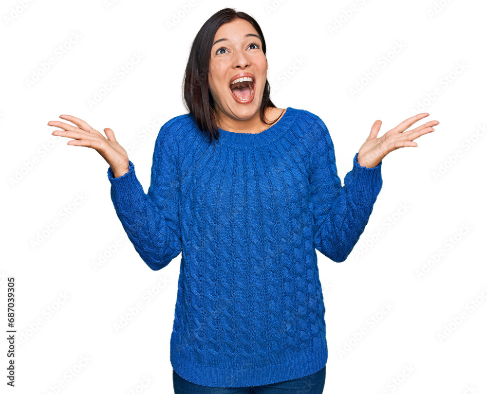 Young hispanic woman wearing casual clothes celebrating crazy and amazed for success with arms raised and open eyes screaming excited. winner concept Young hispanic woman wearing casual clothes celebrating crazy and amazed for success with arms raised and open eyes screaming excited. winner concept