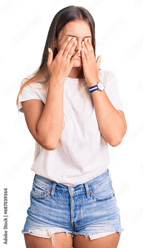Beautiful caucasian woman wearing casual white tshirt rubbing eyes for fatigue and headache, sleepy and tired expression. vision problem Beautiful caucasian woman wearing casual white tshirt rubbing eyes for fatigue and headache, sleepy and tired expression. vision problem