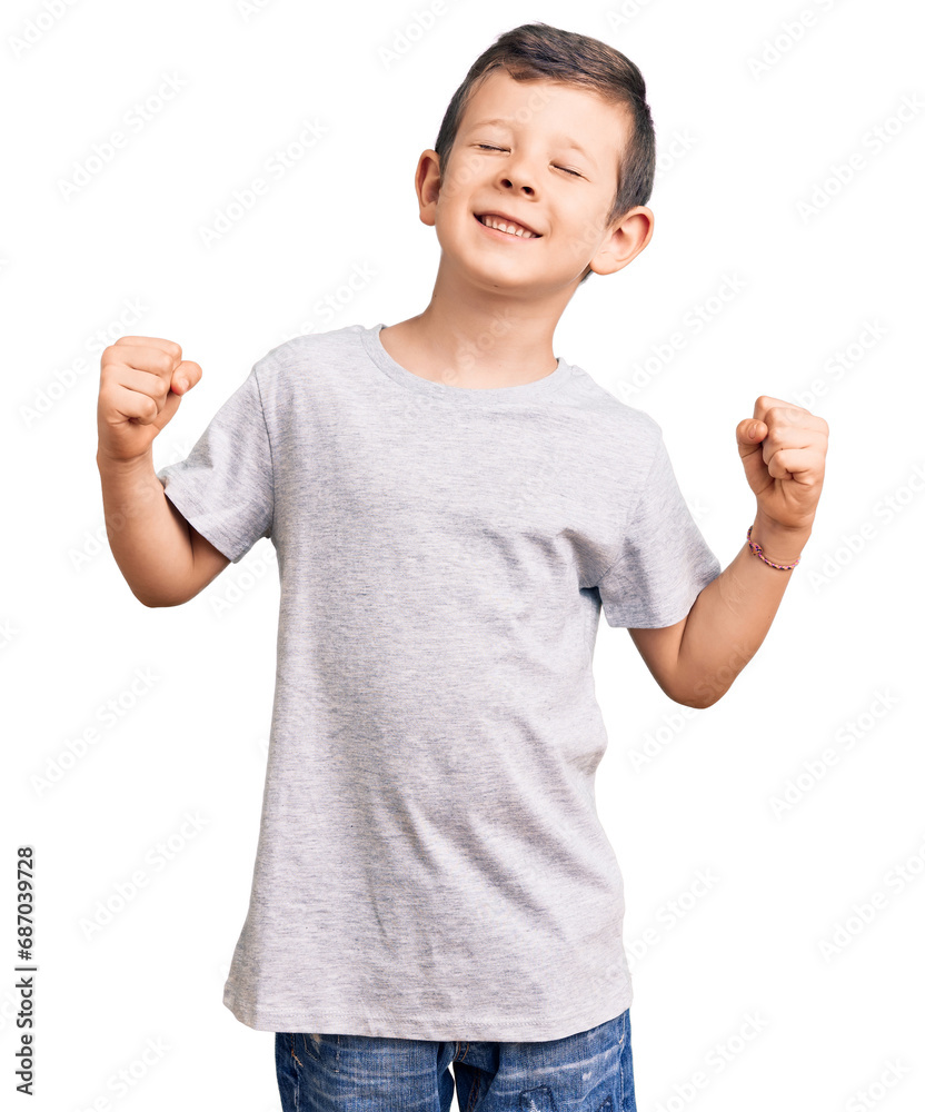 Cute blond kid wearing casual clothes very happy and excited doing winner gesture with arms raised, smiling and screaming for success. celebration concept. Cute blond kid wearing casual clothes very happy and excited doing winner gesture with arms raised, smiling and screaming for success. celebration concept.