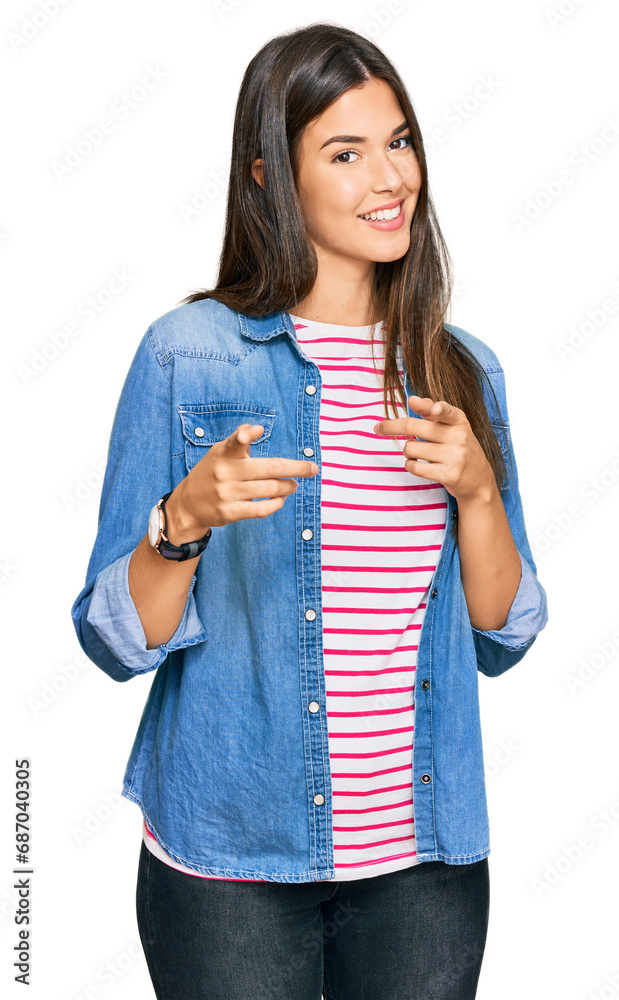 Young brunette woman wearing casual clothes pointing fingers to camera with happy and funny face. good energy and vibes. Young brunette woman wearing casual clothes pointing fingers to camera with happy and funny face. good energy and vibes.
