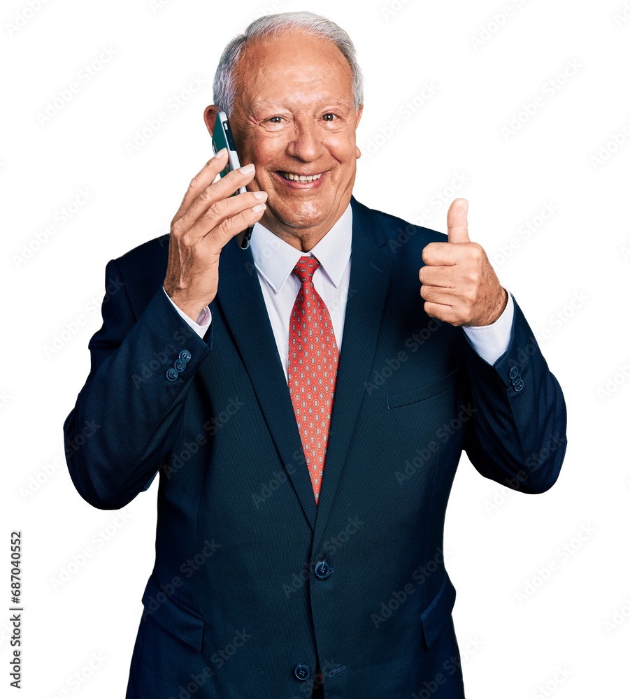Senior business man with grey hair having conversation talking on the smartphone smiling happy and positive, thumb up doing excellent and approval sign Senior business man with grey hair having conversation talking on the smartphone smiling happy and positive, thumb up doing excellent and approval sign