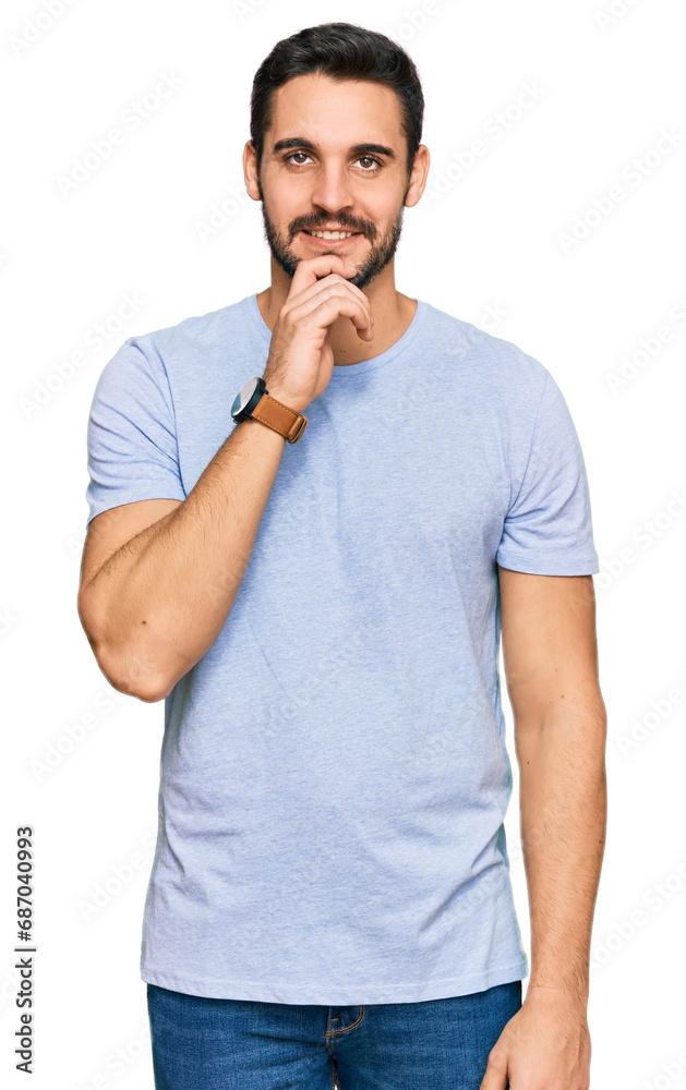 Young hispanic man wearing casual clothes looking confident at the camera smiling with crossed arms and hand raised on chin. thinking positive. Young hispanic man wearing casual clothes looking confident at the camera smiling with crossed arms and hand raised on chin. thinking positive.