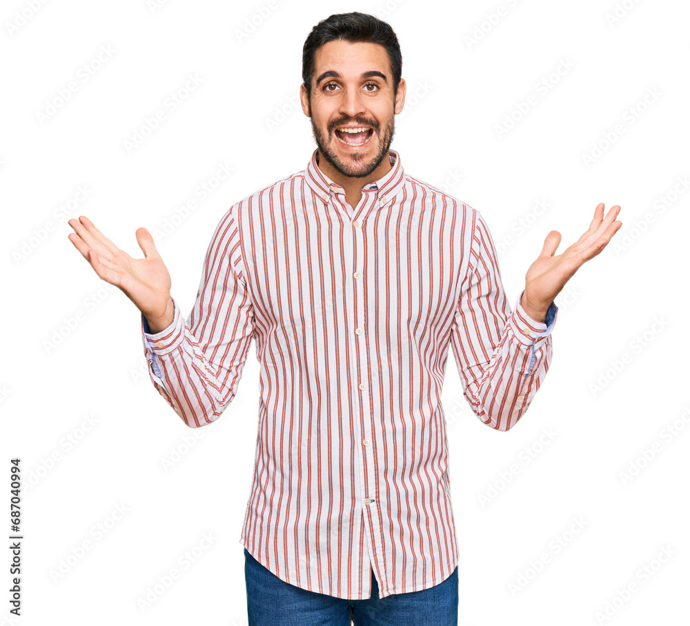 Young hispanic man wearing business shirt celebrating crazy and amazed for success with arms raised and open eyes screaming excited. winner concept Young hispanic man wearing business shirt celebrating crazy and amazed for success with arms raised and open eyes screaming excited. winner concept