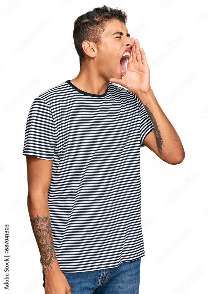 Young handsome african american man wearing casual clothes shouting and screaming loud to side with hand on mouth. communication concept. Young handsome african american man wearing casual clothes shouting and screaming loud to side with hand on mouth. communication concept.