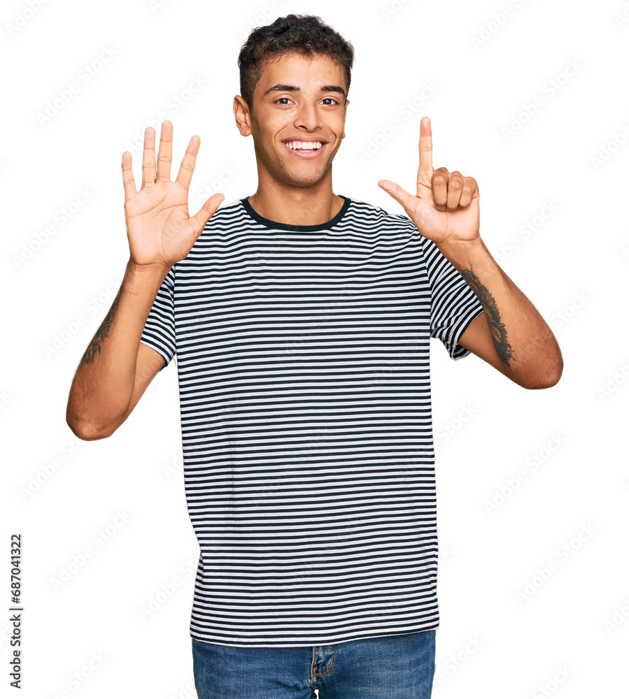 Young handsome african american man wearing casual clothes showing and pointing up with fingers number seven while smiling confident and happy. Young handsome african american man wearing casual clothes showing and pointing up with fingers number seven while smiling confident and happy.