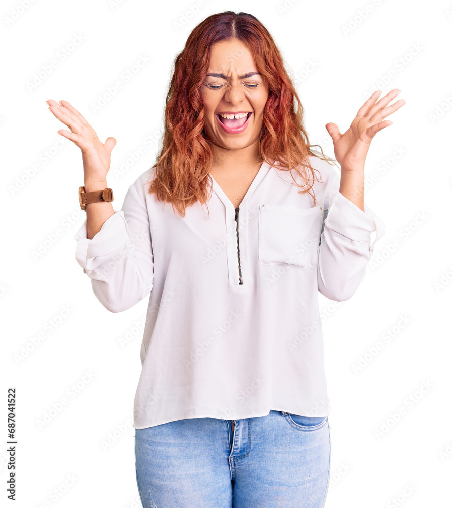 Young latin woman wearing casual clothes celebrating mad and crazy for success with arms raised and closed eyes screaming excited. winner concept Young latin woman wearing casual clothes celebrating mad and crazy for success with arms raised and closed eyes screaming excited. winner concept