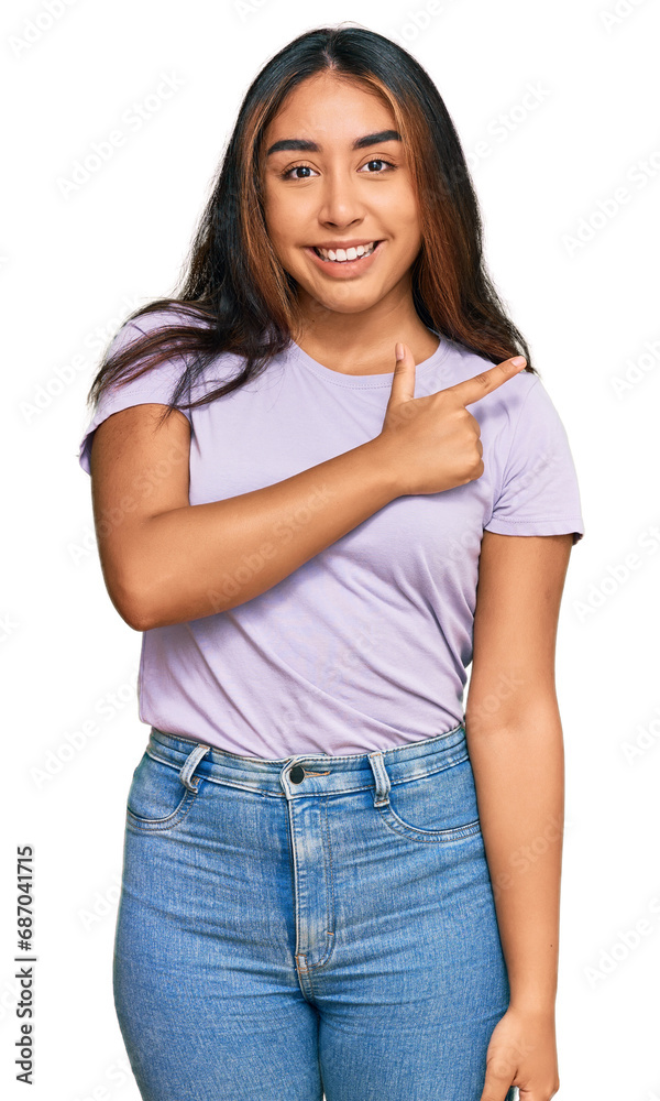 Young latin woman wearing casual clothes cheerful with a smile of face pointing with hand and finger up to the side with happy and natural expression on face