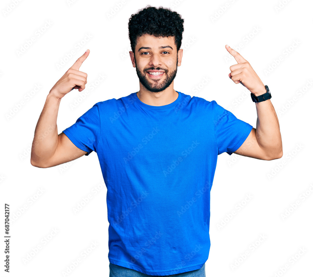 Young arab man with beard wearing casual blue t shirt smiling pointing to head with both hands finger, great idea or thought, good memory Young arab man with beard wearing casual blue t shirt smiling pointing to head with both hands finger, great idea or thought, good memory