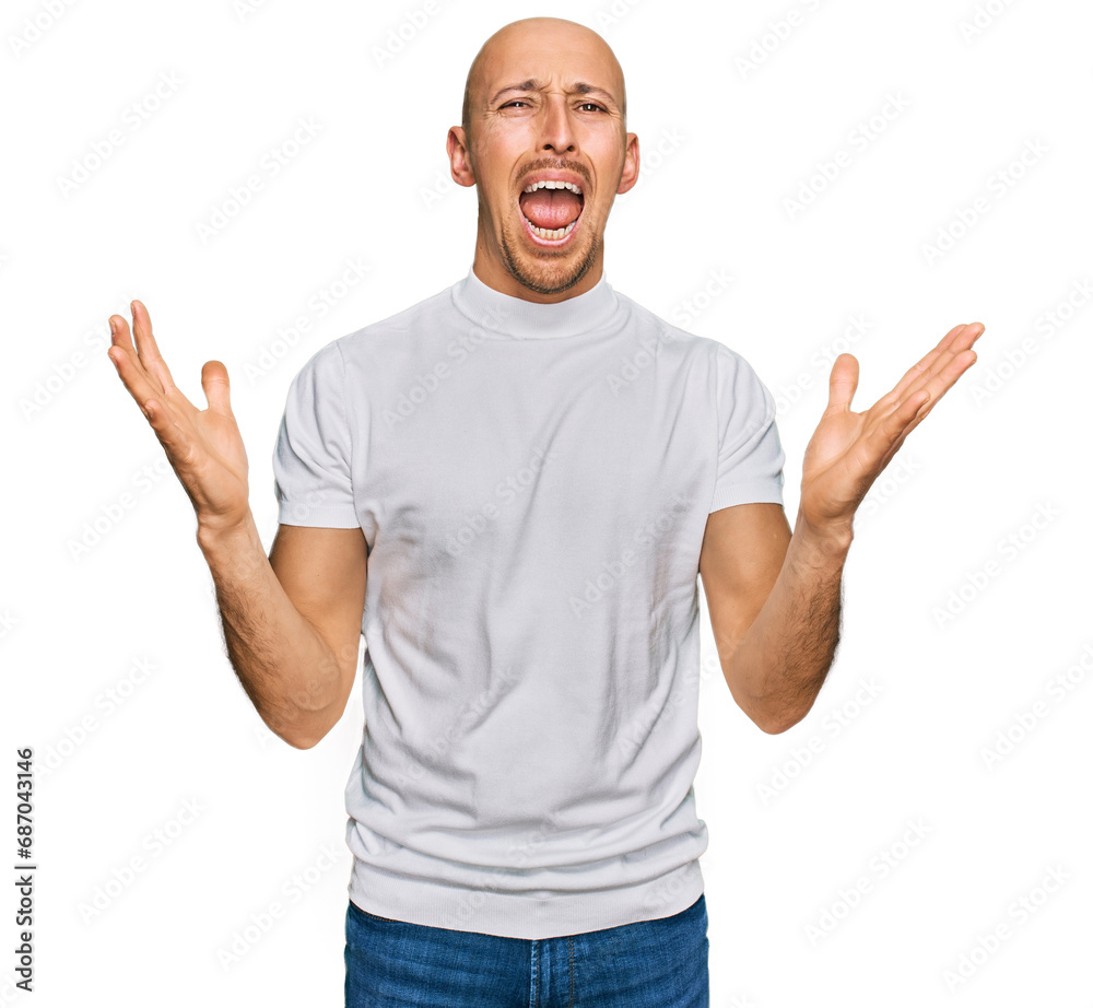 Bald man with beard wearing casual white t shirt crazy and mad shouting and yelling with aggressive expression and arms raised. frustration concept. Bald man with beard wearing casual white t shirt crazy and mad shouting and yelling with aggressive expression and arms raised. frustration concept.
