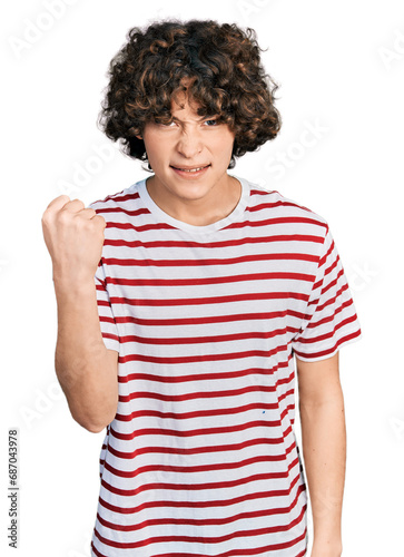 Caucasian teenager wearing casual clothes angry and mad raising fist frustrated and furious while shouting with anger. rage and aggressive concept.