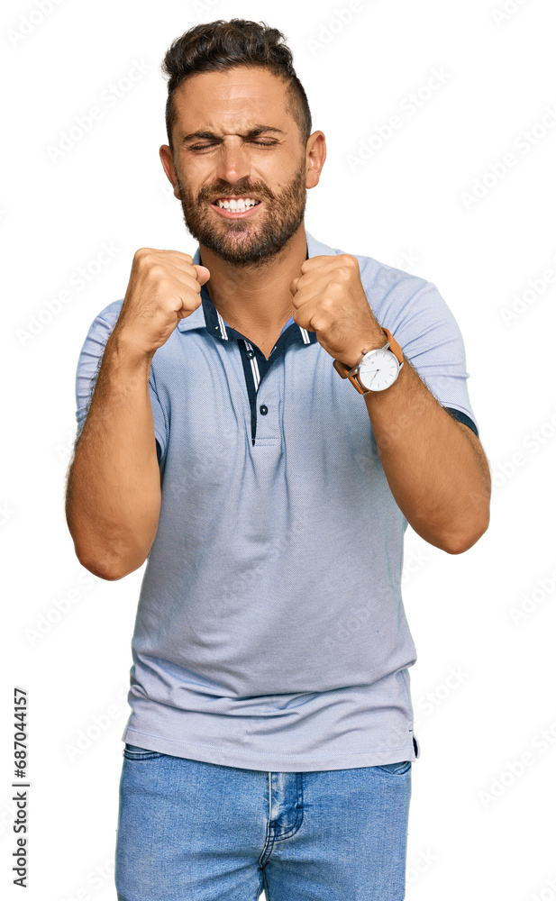 Handsome man with beard wearing casual clothes excited for success with arms raised and eyes closed celebrating victory smiling. winner concept. Handsome man with beard wearing casual clothes excited for success with arms raised and eyes closed celebrating victory smiling. winner concept.