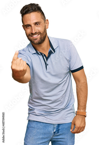 Handsome man with beard wearing casual clothes beckoning come here gesture with hand inviting welcoming happy and smiling