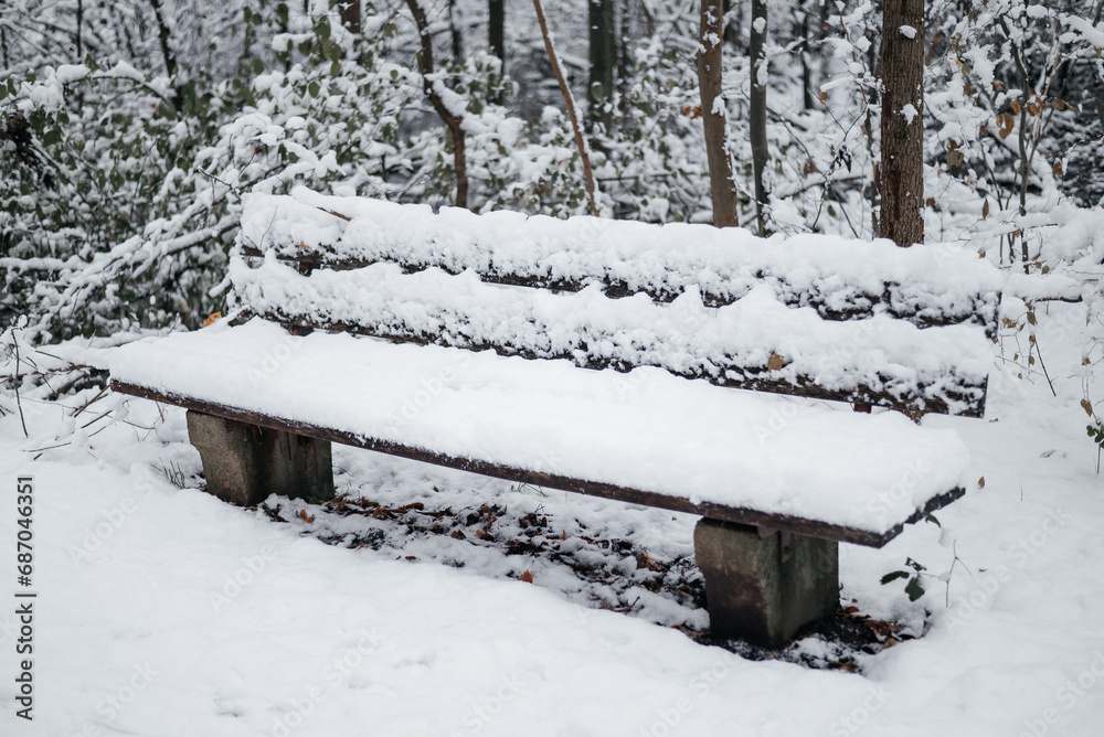 snow-covered bench and rubbish bin in the park snow-covered bench and rubbish bin in the park