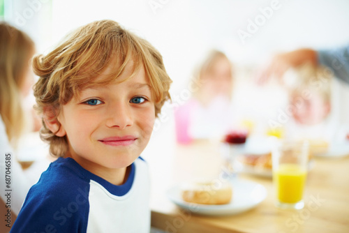 Kid, breakfast and portrait at home in the morning with food, smile and happy from eating. Family, dinner table and hungry young child with meal for health and nutrition in a house with juice