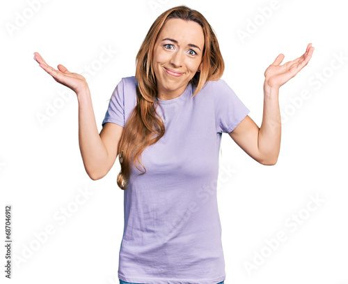 Young caucasian woman wearing casual clothes clueless and confused with open arms, no idea and doubtful face.