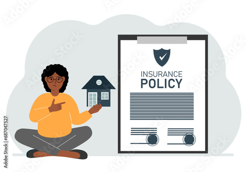 A woman holds in his hands at home next to a large insurance contract. Home and real estate insurance concept.