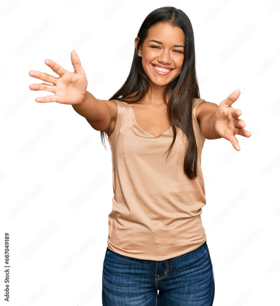 Beautiful hispanic woman wearing casual clothes looking at the camera smiling with open arms for hug. cheerful expression embracing happiness. Beautiful hispanic woman wearing casual clothes looking at the camera smiling with open arms for hug. cheerful expression embracing happiness.