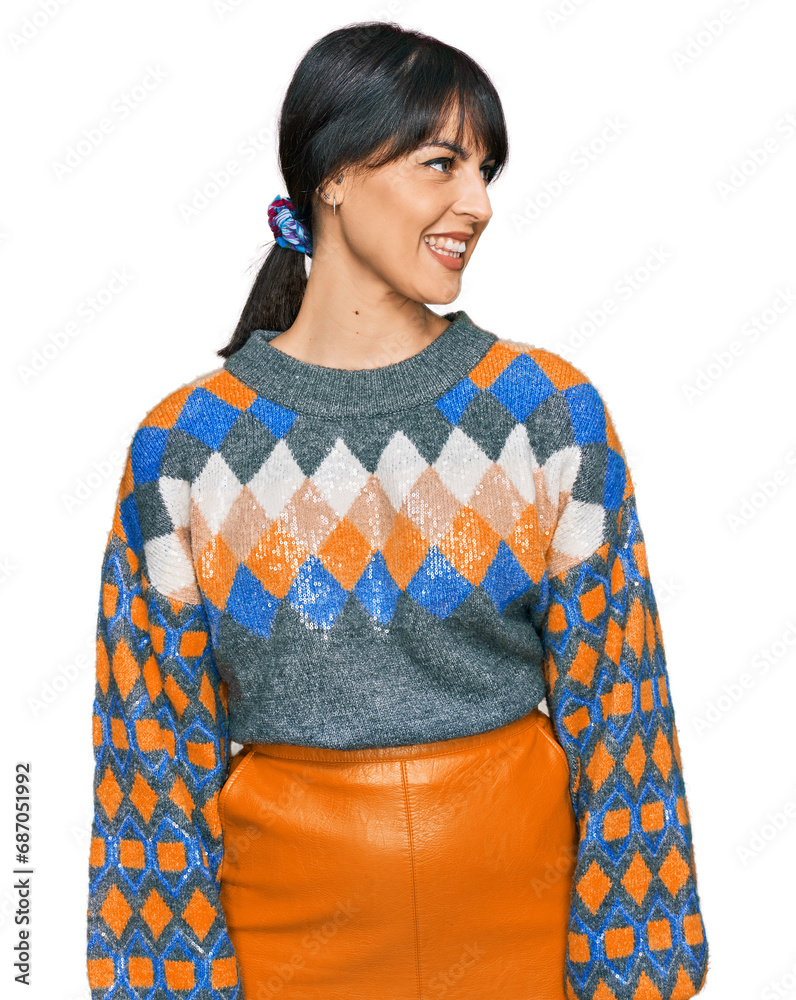 Young hispanic woman wearing casual clothes looking away to side with smile on face, natural expression. laughing confident.