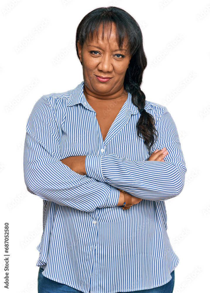 Hispanic middle age woman wearing casual clothes skeptic and nervous, disapproving expression on face with crossed arms. negative person. Hispanic middle age woman wearing casual clothes skeptic and nervous, disapproving expression on face with crossed arms. negative person.