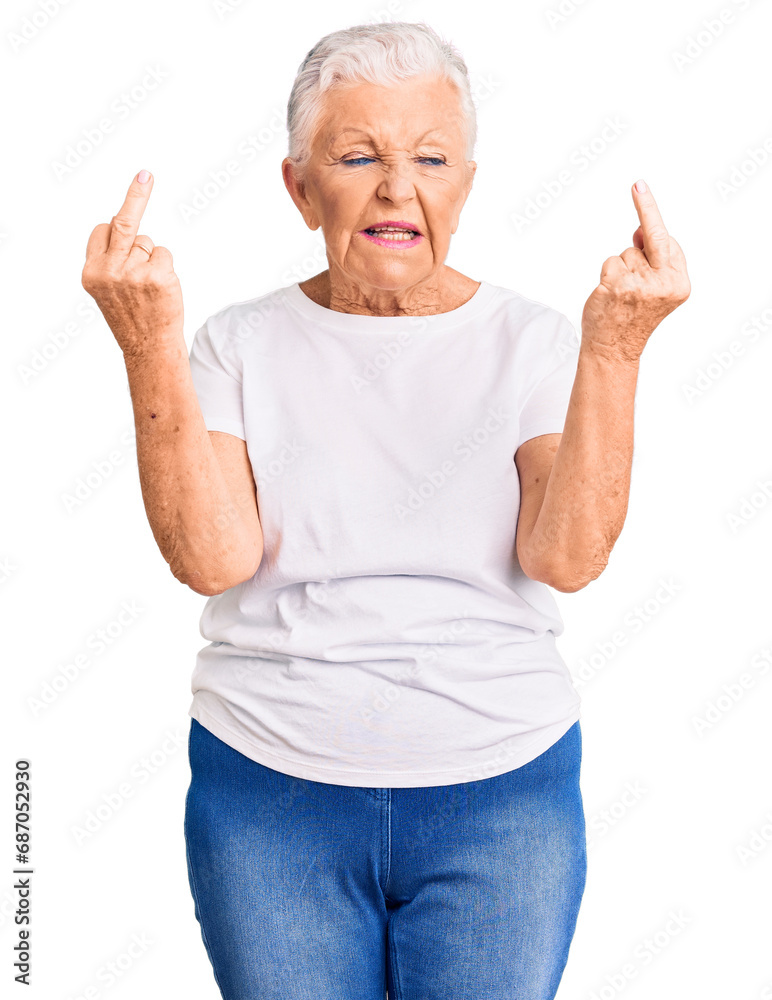 Senior beautiful woman with blue eyes and grey hair wearing casual white tshirt showing middle finger doing fuck you bad expression, provocation and rude attitude. screaming excited Senior beautiful woman with blue eyes and grey hair wearing casual white tshirt showing middle finger doing fuck you bad expression, provocation and rude attitude. screaming excited