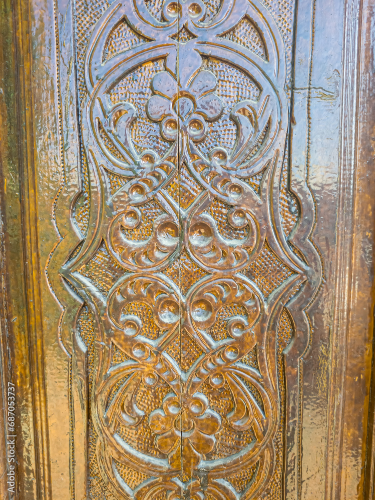 An old wooden door with Arabic carvings