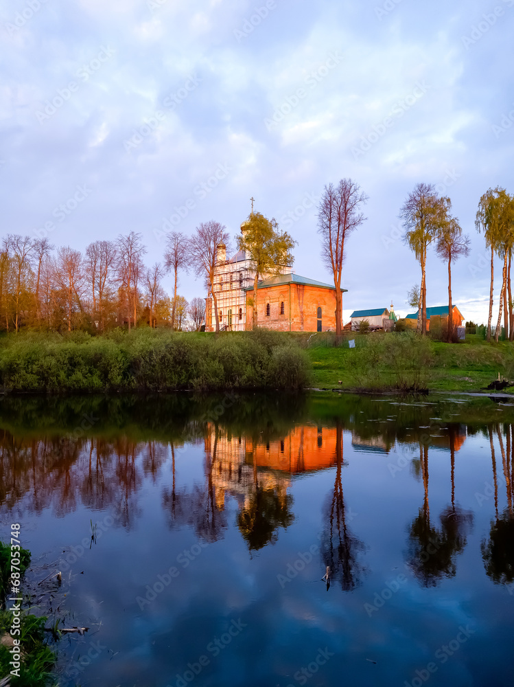 The old Orthodox church on the shore of the lake at sunset The old Orthodox church on the shore of the lake at sunset