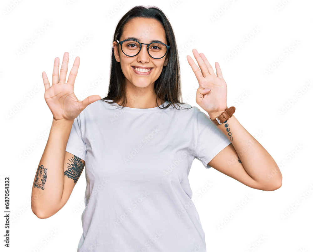 Young hispanic woman wearing casual white t shirt showing and pointing up with fingers number nine while smiling confident and happy. Young hispanic woman wearing casual white t shirt showing and pointing up with fingers number nine while smiling confident and happy.