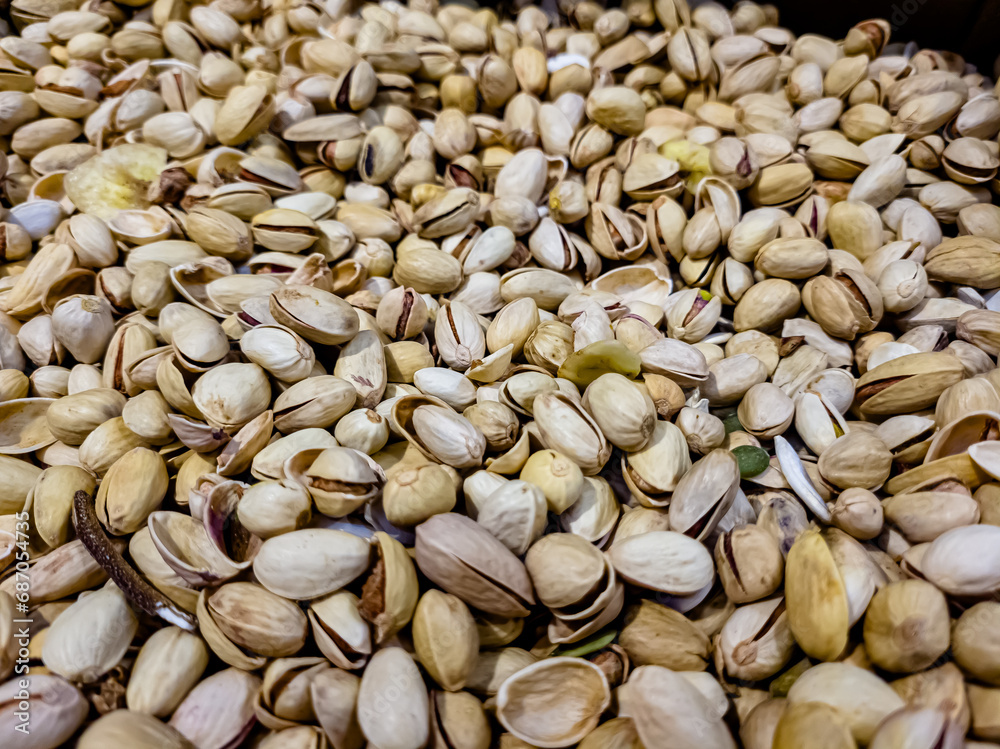 a lot of nuts: almonds, peanuts, pistachios are in a box in the store. a lot of nuts: almonds, peanuts, pistachios are in a box in the store.