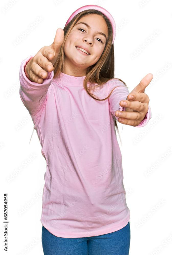 Beautiful brunette little girl wearing casual turtleneck sweater looking at the camera smiling with open arms for hug. cheerful expression embracing happiness. Beautiful brunette little girl wearing casual turtleneck sweater looking at the camera smiling with open arms for hug. cheerful expression embracing happiness.
