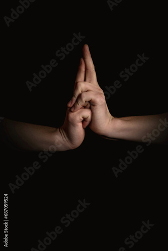 human hands with anime gestures on a black background