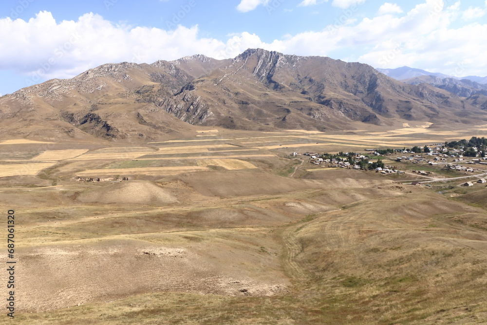 Mountain plateau over small village, road to Kazarman, district of Jalal-Abad Region in western Kyrgyzstan