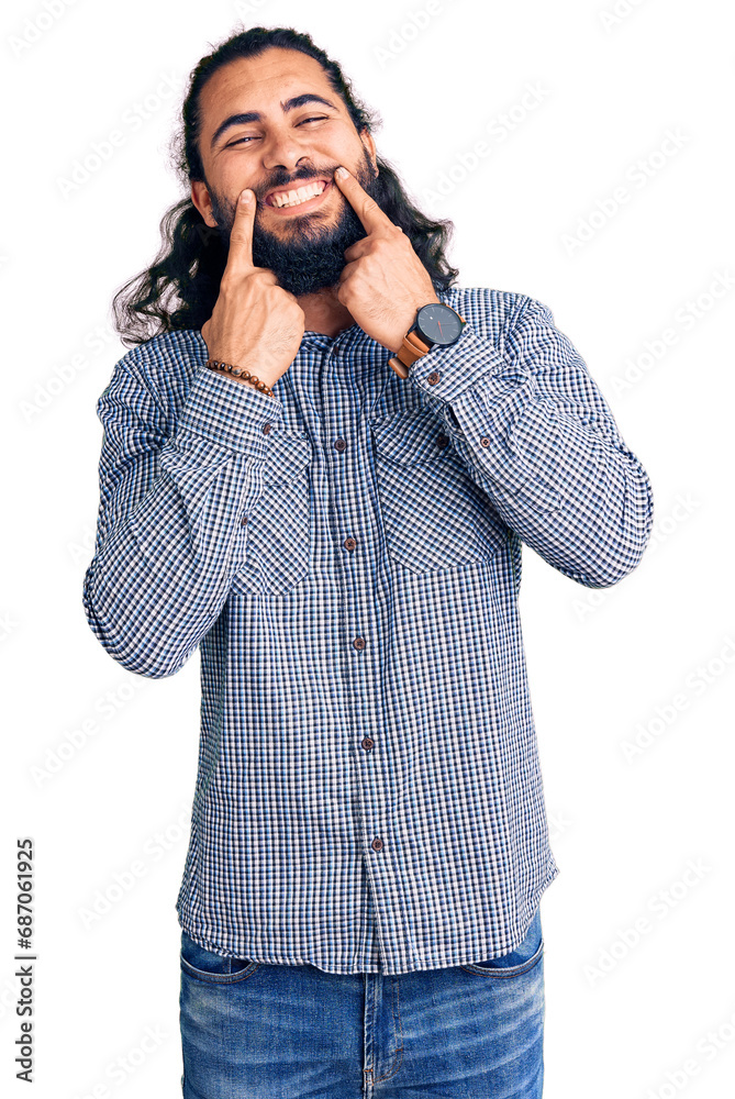 Young arab man wearing casual clothes smiling with open mouth, fingers pointing and forcing cheerful smile Young arab man wearing casual clothes smiling with open mouth, fingers pointing and forcing cheerful smile
