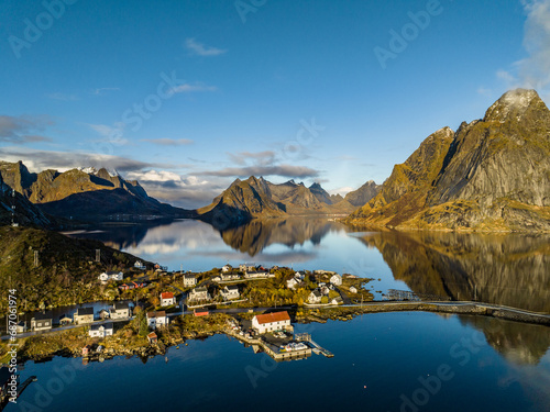 aerial view over reine nordic norwegian village surrounded with moountains with reflections on lofoten islands photo