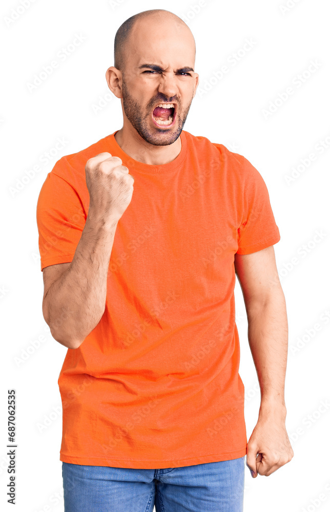 Young handsome man wering casual t shirt angry and mad raising fist frustrated and furious while shouting with anger. rage and aggressive concept. Young handsome man wering casual t shirt angry and mad raising fist frustrated and furious while shouting with anger. rage and aggressive concept.