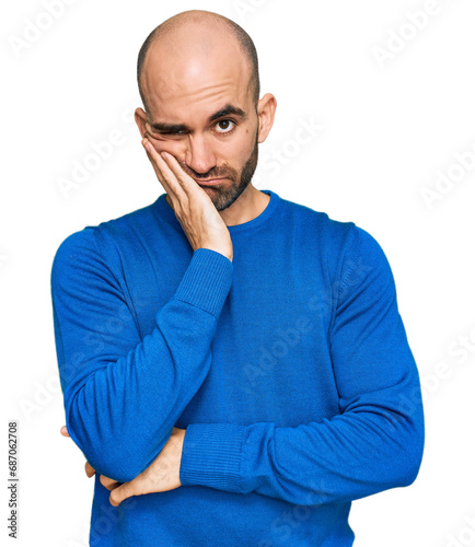 Young hispanic man wearing casual clothes thinking looking tired and bored with depression problems with crossed arms. photo