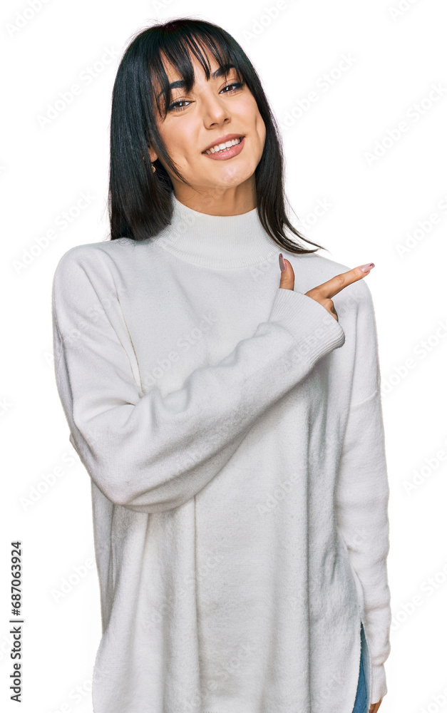 Young brunette woman with bangs wearing casual turtleneck sweater cheerful with a smile of face pointing with hand and finger up to the side with happy and natural expression on face Young brunette woman with bangs wearing casual turtleneck sweater cheerful with a smile of face pointing with hand and finger up to the side with happy and natural expression on face