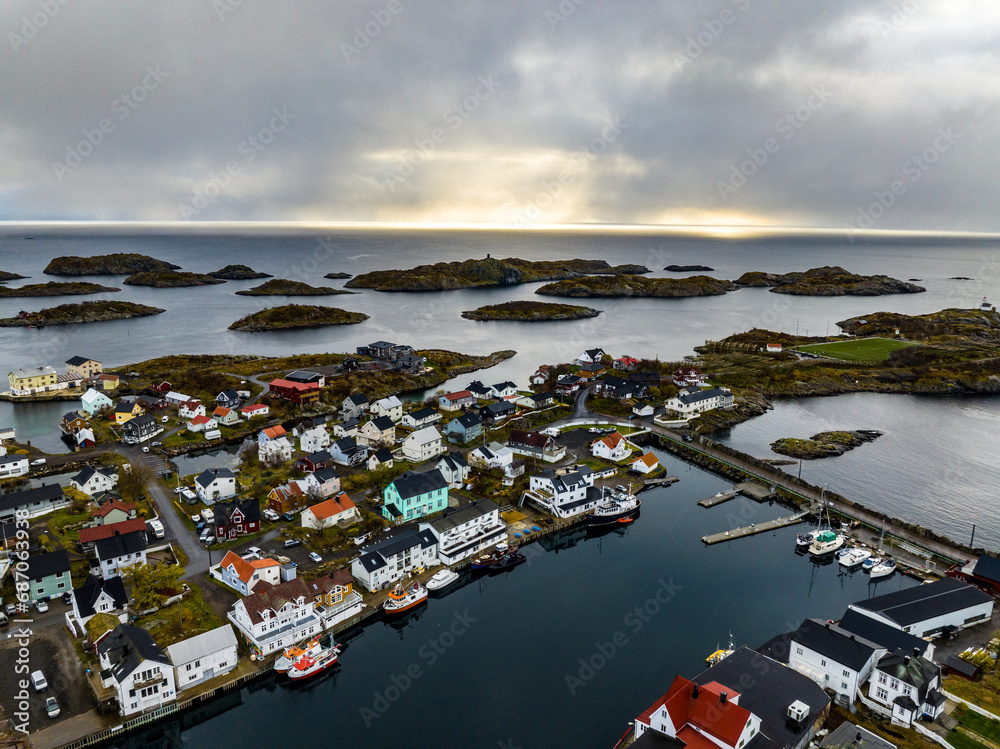 Henningsvaer village houses on islands with boats on lofoten islands in norway, aerial view