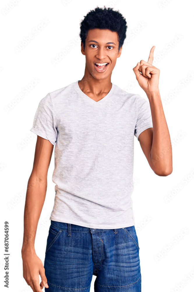 Young african american man wearing casual white t shirt pointing finger up with successful idea. exited and happy. number one. Young african american man wearing casual white t shirt pointing finger up with successful idea. exited and happy. number one.